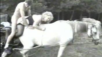 A bleached pony is enthusiastically pounded by a lusty young farmer